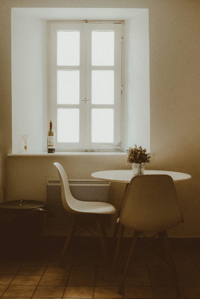 White and brown wooden chairs near table